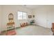 Spacious bedroom with a large window, light-colored carpet, and minimalistic decor at 7045 Judith River St, North Las Vegas, NV 89084