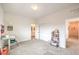 A bedroom with neutral walls, carpet flooring, and modern ceiling light fixture and open closet at 7045 Judith River St, North Las Vegas, NV 89084