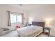 Comfortable bedroom with carpet floors, soft natural light, and minimalist modern decor at 7045 Judith River St, North Las Vegas, NV 89084