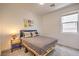 Cozy bedroom with carpeted floors, a queen sized bed, and a bright window view at 7045 Judith River St, North Las Vegas, NV 89084