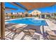 Beautiful community pool with shaded lounge areas, perfect for relaxation and summer fun at 7045 Judith River St, North Las Vegas, NV 89084