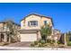 Charming two-story home with a well-manicured front yard, landscaping and a two-car garage at 7045 Judith River St, North Las Vegas, NV 89084