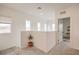 Bright hallway features neutral walls, carpet flooring, natural light, and views from the windows at 7045 Judith River St, North Las Vegas, NV 89084