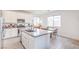 Bright kitchen with stainless steel appliances, grey countertops, and wood-look tile at 7045 Judith River St, North Las Vegas, NV 89084