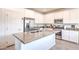 Spacious kitchen with a large island, stainless steel appliances, and white cabinets at 7045 Judith River St, North Las Vegas, NV 89084