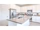 Kitchen with stainless steel appliances, island with sink, and white cabinets at 7045 Judith River St, North Las Vegas, NV 89084