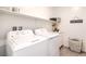 Well-lit laundry room with modern appliances, cabinetry, and stylish decor at 7045 Judith River St, North Las Vegas, NV 89084