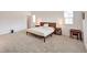 Spacious main bedroom featuring neutral walls, carpet floors, minimalist decor and plenty of natural light at 7045 Judith River St, North Las Vegas, NV 89084