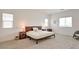 Spacious main bedroom features neutral walls, carpet floors, natural light, and minimalist decor at 7045 Judith River St, North Las Vegas, NV 89084