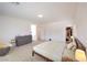 Bright main bedroom featuring a walk-in closet, ensuite bathroom, and neutral carpeting at 7045 Judith River St, North Las Vegas, NV 89084