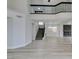Open floor plan features wood-look floors, modern fireplace, and black metal staircase at 71 Sea Holly Way, Henderson, NV 89074