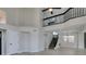 Open floor plan with soaring ceilings, black metal staircase, and modern ceiling fan at 71 Sea Holly Way, Henderson, NV 89074