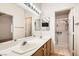 Bathroom features a double vanity sink, walk-in shower, and nice lighting at 735 Wolf Point St, Henderson, NV 89002