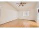 Cozy bedroom features wood-look flooring, a window, and neutral wall paint at 735 Wolf Point St, Henderson, NV 89002