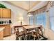 Bright dining area with tile floors, a wooden table set, and a large window with plantation blinds offers an inviting space at 735 Wolf Point St, Henderson, NV 89002