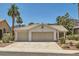 Charming single-story home with a two-car garage, desert landscaping, and mature palm trees in a desirable neighborhood at 735 Wolf Point St, Henderson, NV 89002