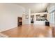 Open living room with wood floors and high ceilings offer a seamless transition into other living spaces of the home at 735 Wolf Point St, Henderson, NV 89002