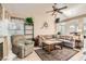 Comfortable living room featuring a neutral sectional sofa, fireplace, and tile flooring for a cozy gathering space at 735 Wolf Point St, Henderson, NV 89002