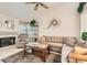 Inviting living room with a sectional sofa, fireplace, tile flooring and lots of natural light for a bright and airy feel at 735 Wolf Point St, Henderson, NV 89002