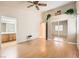 Spacious main bedroom with vaulted ceiling, ceiling fan, wood-look floors, and a sliding door mirrored closet at 735 Wolf Point St, Henderson, NV 89002
