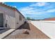 Side yard with gravel landscaping, offering low maintenance and clean appearance at 7820 Milkweed Ct, Las Vegas, NV 89149