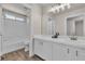 Bright bathroom featuring double sink vanity and tiled shower for a relaxing and functional space at 7820 Milkweed Ct, Las Vegas, NV 89149