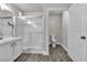 The spacious bathroom features a modern glass shower and white cabinets and countertops at 7820 Milkweed Ct, Las Vegas, NV 89149