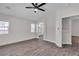 Spacious bedroom featuring wood-look floors, a ceiling fan, and an ensuite bathroom at 7820 Milkweed Ct, Las Vegas, NV 89149