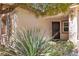 Inviting front entrance with a decorative screen door, desert landscaping, and an outdoor light fixture at 7820 Milkweed Ct, Las Vegas, NV 89149