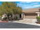 Single-story home featuring a well-manicured lawn, desert landscaping, and a two-car garage at 7820 Milkweed Ct, Las Vegas, NV 89149