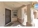 Covered front porch with a decorative security door, a welcome mat, and exterior lighting at 7820 Milkweed Ct, Las Vegas, NV 89149