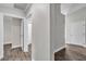 Bright hallway with wood-look flooring and fresh white trim and doors creates a welcoming transition between rooms at 7820 Milkweed Ct, Las Vegas, NV 89149