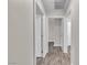Hallway featuring white trim, wood-look flooring, and white doors provide a clean, updated look at 7820 Milkweed Ct, Las Vegas, NV 89149
