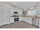 Updated kitchen features stainless steel appliances, white cabinets, and tile backsplash at 7820 Milkweed Ct, Las Vegas, NV 89149