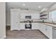 Bright kitchen featuring stainless steel appliances, white cabinetry, and tile backsplash at 7820 Milkweed Ct, Las Vegas, NV 89149