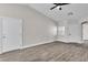Open living room featuring wood-look floors, a ceiling fan, and two entry doors at 7820 Milkweed Ct, Las Vegas, NV 89149