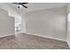 Spacious living room showcasing wood-look floors, recessed lighting, and access to the kitchen at 7820 Milkweed Ct, Las Vegas, NV 89149