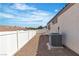 Gravel side yard with fencing and AC unit, offering practical outdoor space at 7820 Milkweed Ct, Las Vegas, NV 89149