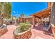 Outdoor living in this charming backyard with a covered patio, a grill, and a brick water feature at 7959 Palace Monaco Ave, Las Vegas, NV 89117
