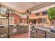 This backyard bar is set against the home, including a refrigerator and BBQ area at 7959 Palace Monaco Ave, Las Vegas, NV 89117