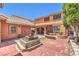 Backyard BBQ area with a fire pit is ready for entertaining, framed by the home's elevation at 7959 Palace Monaco Ave, Las Vegas, NV 89117