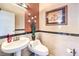 Convenient half bath features tile walls, marble-look accents, and is perfect for guests at 7959 Palace Monaco Ave, Las Vegas, NV 89117