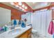 Clean bathroom with single sink, wooden cabinets, and shower/tub combo at 7959 Palace Monaco Ave, Las Vegas, NV 89117