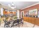 Elegant dining area with tile flooring, a dining table, stylish light fixture, and bar seating in the kitchen at 7959 Palace Monaco Ave, Las Vegas, NV 89117
