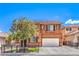 Inviting two-story home with a well-kept front yard, charming tree, and a convenient two-car garage at 7959 Palace Monaco Ave, Las Vegas, NV 89117