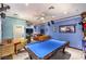 Spacious game room features a billiards table, ample seating, and unique wall decor at 7959 Palace Monaco Ave, Las Vegas, NV 89117