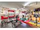Home gym with various equipment, including weights, machines, and workout area at 7959 Palace Monaco Ave, Las Vegas, NV 89117