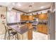 Modern kitchen featuring stainless steel appliances, granite countertops, and ample cabinet space with bar seating at 7959 Palace Monaco Ave, Las Vegas, NV 89117