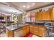Cozy kitchen featuring granite countertops, stainless steel appliances, and direct views into the living space at 7959 Palace Monaco Ave, Las Vegas, NV 89117