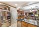 Open concept kitchen boasting stainless steel appliances and sleek granite counters adjacent to living area at 7959 Palace Monaco Ave, Las Vegas, NV 89117